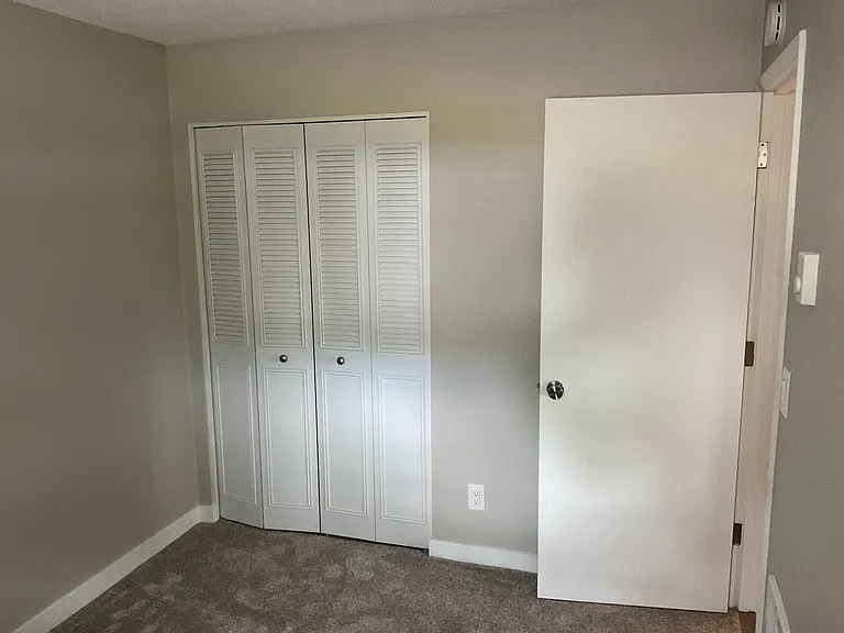 Bedroom 11'x13', large window looking out back of house to fenced patio area
