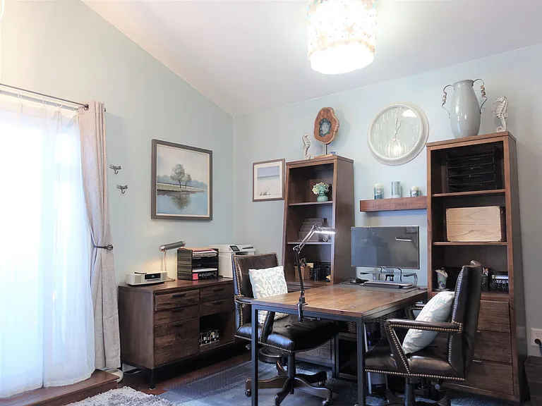 Office den with a skylight and office supplies.