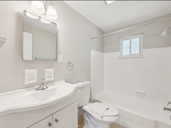 Bathroom is complete with shower fixture and ample storage