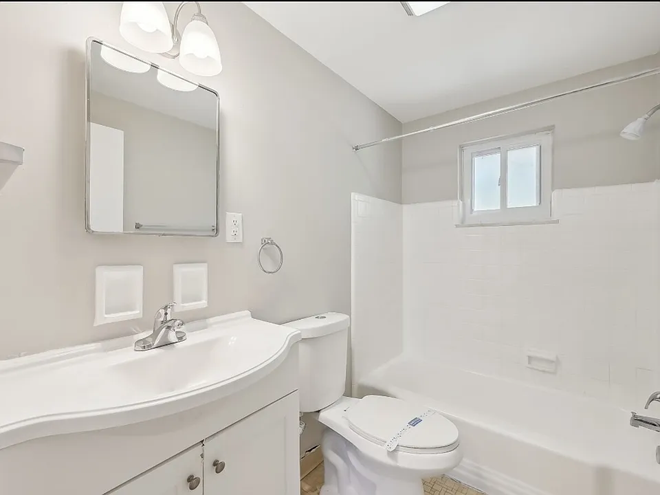 Bathroom is complete with shower fixture and ample storage