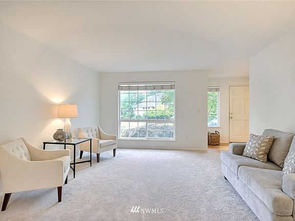 Spacious living room with big picture window with views of Mt. Rainier
