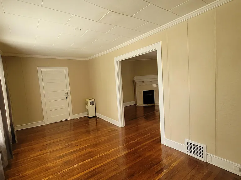 Front parlor sunroom looking into living room with fireplace