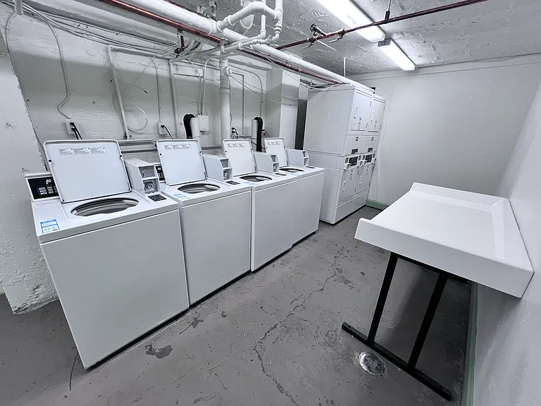 Laundry room in basement accepts quarters or app for payment. The app has a progress timeline, so you don't have to wait for laundry; you'll know when it's ready.