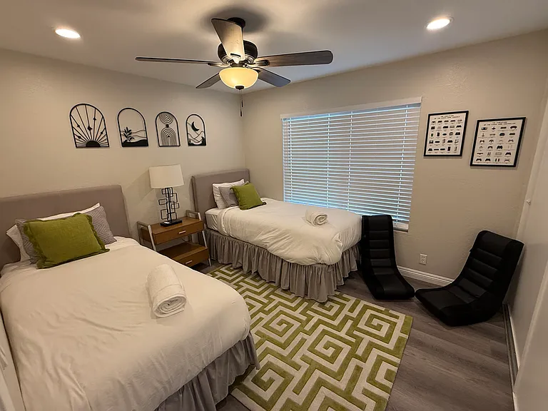 Bedroom 2 with recessed lighting and fan/light. 8 ft closet on the right.