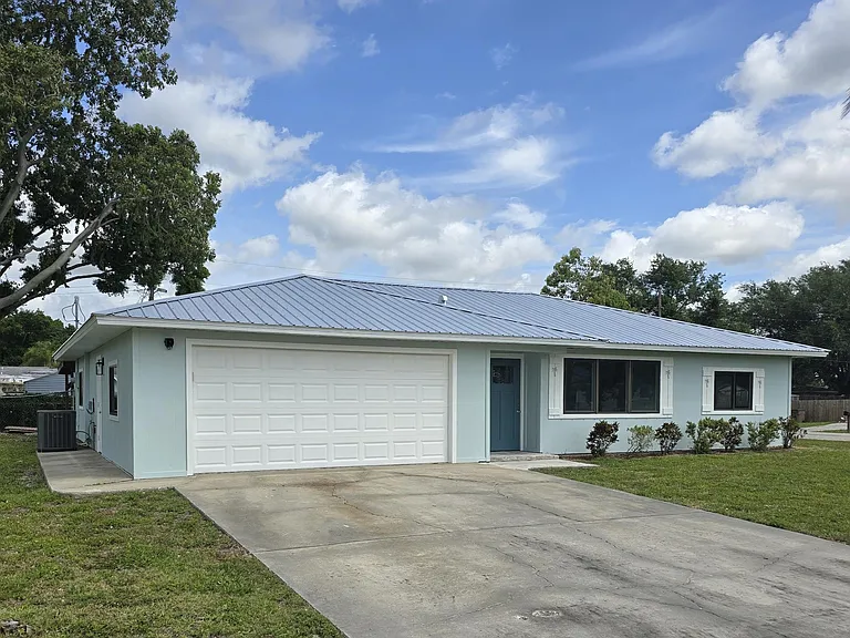 Front View - One level three bedroom, two bath home with 2-stall attached garage.