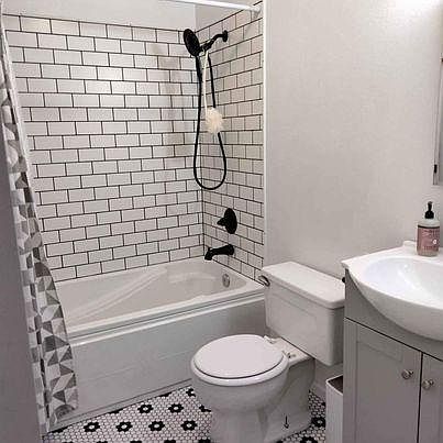 newly remodeled bathroom with tub and shower, adjacent to bedrooms