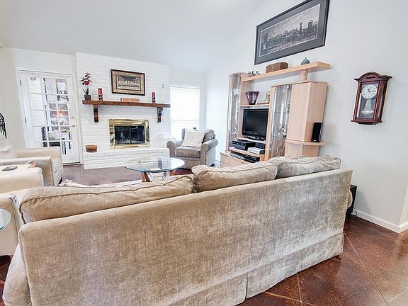 Living Room 1: The door to the left of the fireplace is access to the mud room and bonus room (den)