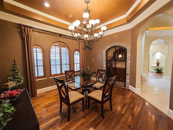 Formal Dinning with built-in wine cellar. Vaulted ceiling, subtle European finishes on walls & rich, wide plank flooring.