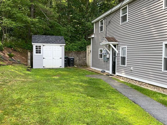 Apartment A front door and yard and shed