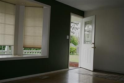 This home features a tile entryway with bay window seating area and fireplace complete with a sittin