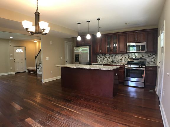 Open plan kitchen with island, granite countertops, and stainless steel appliances