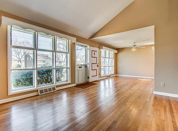 Gleaming hardwoods & soaring vaulted ceiling in LR