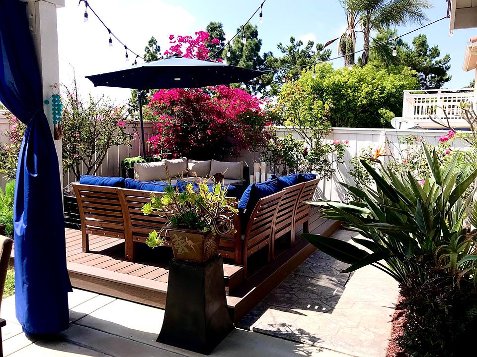 backyard deck with seating, umbella, firepit