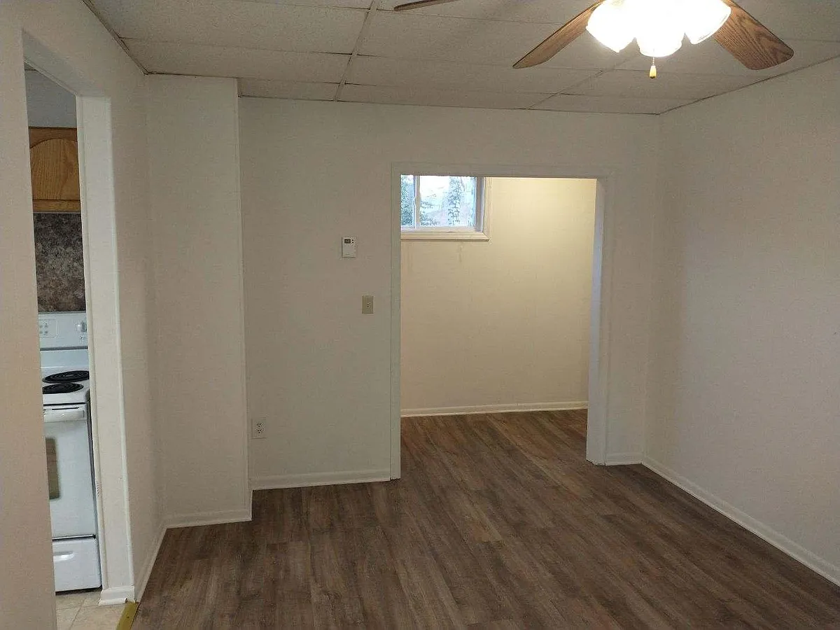 Living Room 
Vinyl plank flooring 
Looking into hallway - 111 Spring St #1