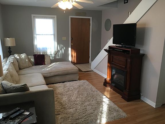 Living room from Dining room - back of front door and stairs to upstairs bedrooms and bathroom.