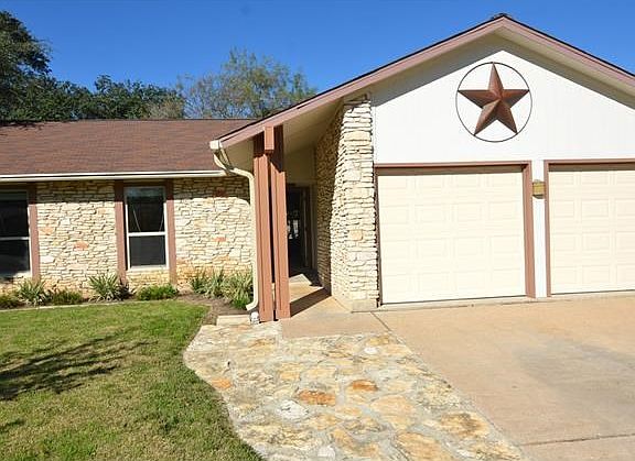Stone work extends the parking surface.