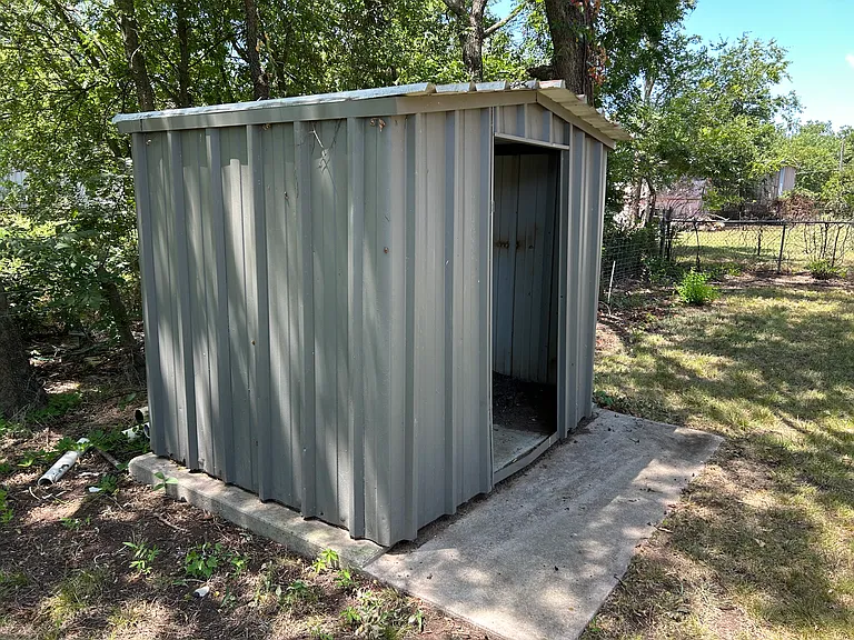 Metal storage shed in back.