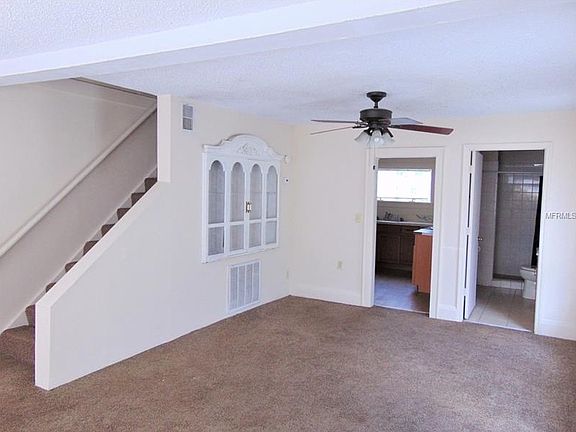 Living room leading to kitchen and bath