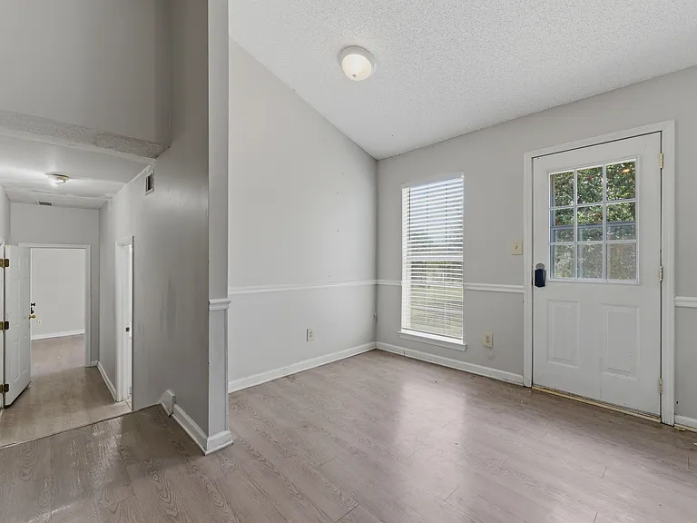 Entry area with durable flooring, a window for natural light, and a glass-panel exterior door for easy access.