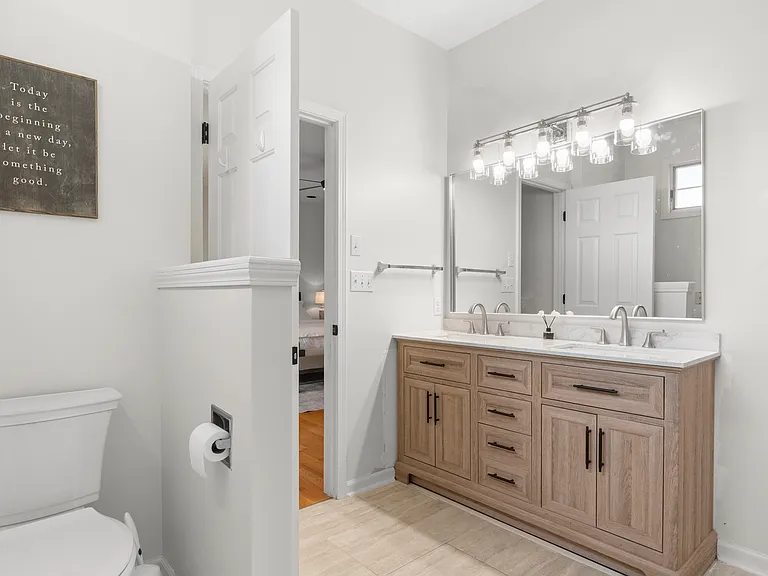 Private primary ensuite bathroom with a double vanity, separate shower, and relaxing Jacuzzi tub.