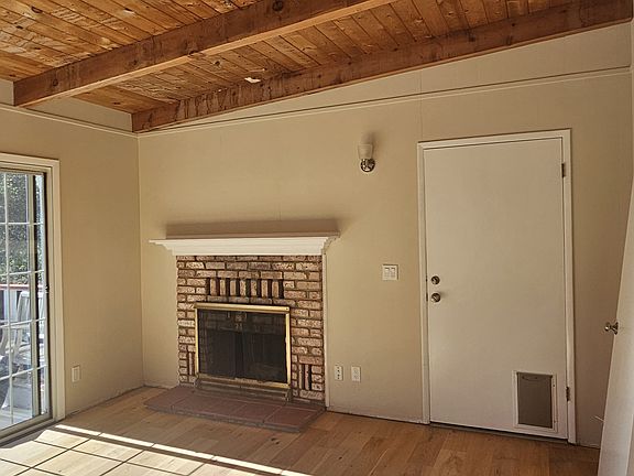 Livingroom w/wood burning fireplace. Sliding door on left leads to a good sized deck.