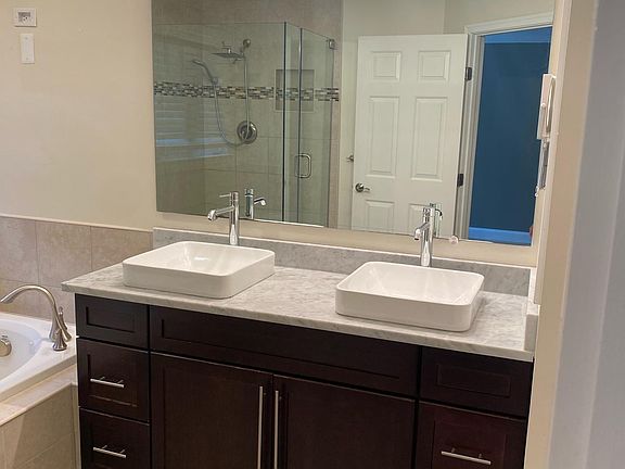 Master bathroom with dual sinks. New faucets installed. Bathroom lights are on a dimmer.