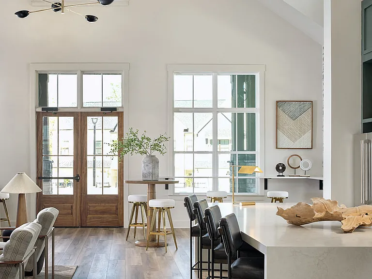 Inviting clubhouse space bathed in natural light with modern seating throughout.