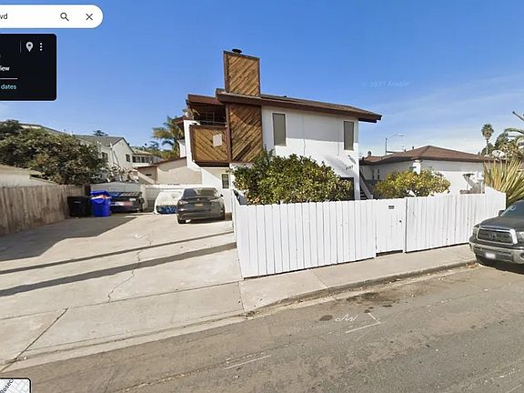This house's lot is shared with a small apartment complex. It does not have a private backyard.