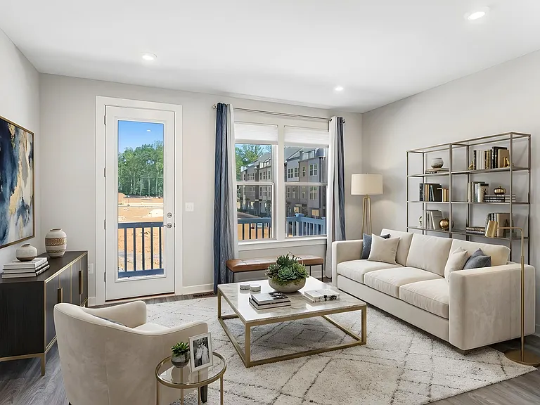 Open and airy living room seamlessly connects to a private balcony, creating the ideal indoor-outdoor living experience. Virtually staged.