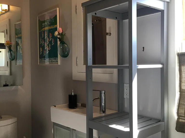 Remodeled bathroom is bright and clean, with lots of storage