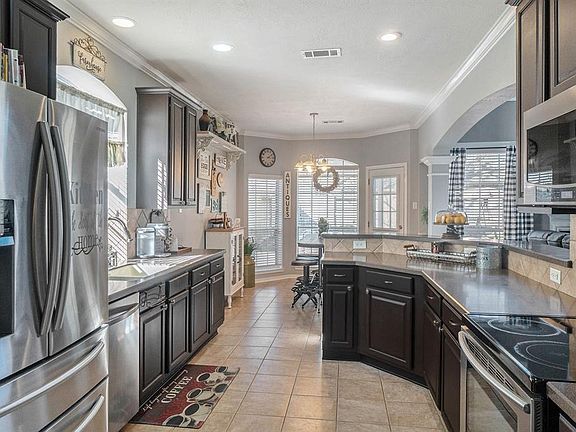 Look at this pretty kitchen with silestone countertops and stainless appliances including new dishwasher and new combination microwave/convection oven.