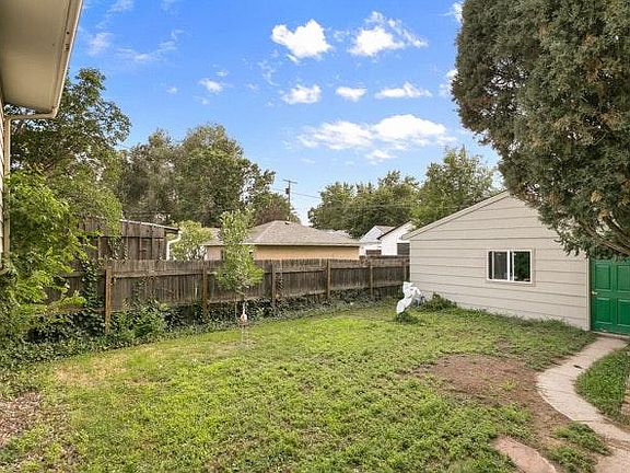 Backyard. Grass to be replaced with small sized gravel for updated yard.