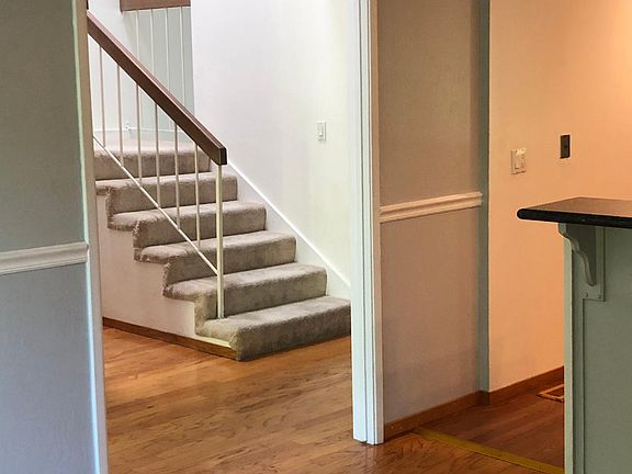 Kitchen hardwood leading to upstairs stairway.