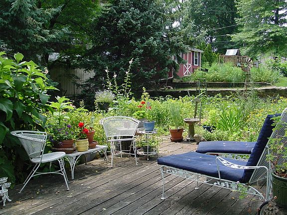 Deck surrounded by serene organic gardens.