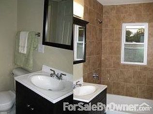 Bathroom : New tub, vanity & toilet with new tile floor and tub surround