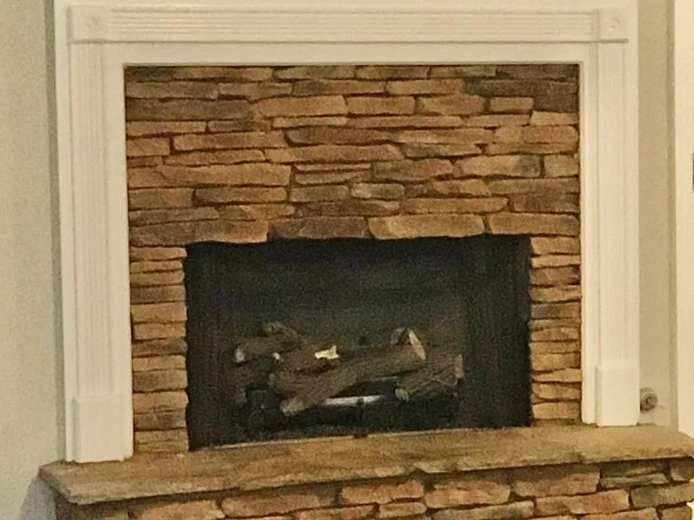 Gas fireplace with gas logs (in living room)