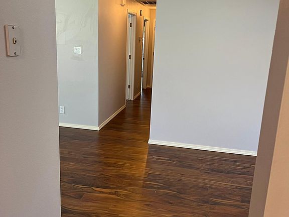 Standing in the kitchen looking out to the dining area and the hallway leading to the bedrooms and guest bathroom
