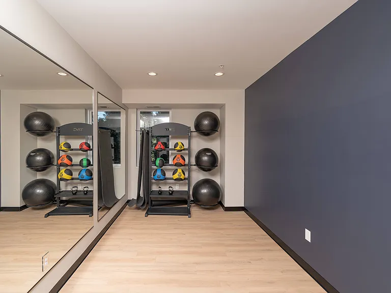 A dedicated area with mirrors and weights for strength and mobility training.