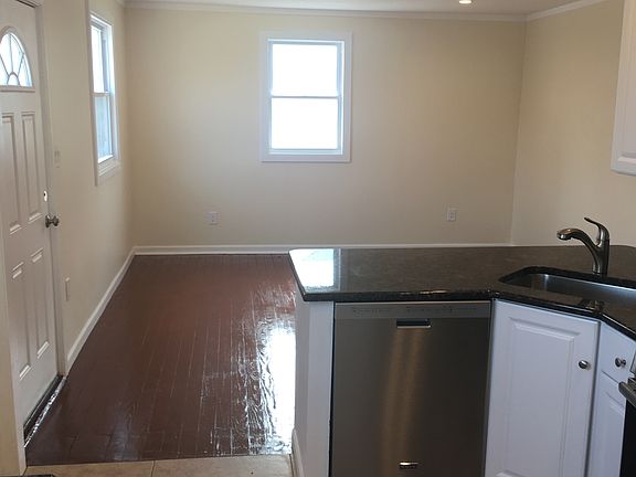 Open floor plan with kitchen opening to the living room.