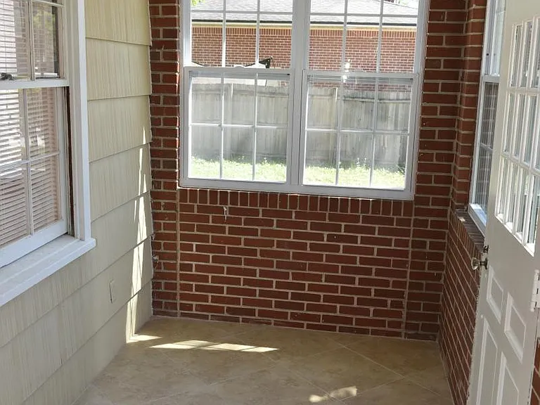 Enclosed sun porch: Porcelain tile, double pane windows, decorative light