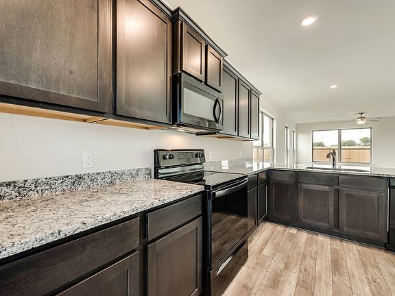 Enjoy gorgeous granite countertops and designer wood cabinetry in this home.