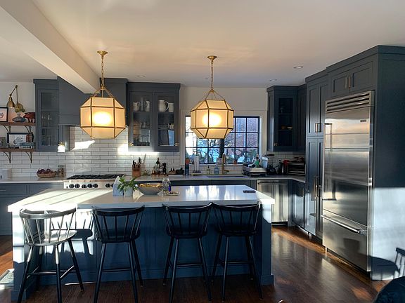 Stainless steel appliances and commercial stove make this chef's kitchen a great work and entertaining space.