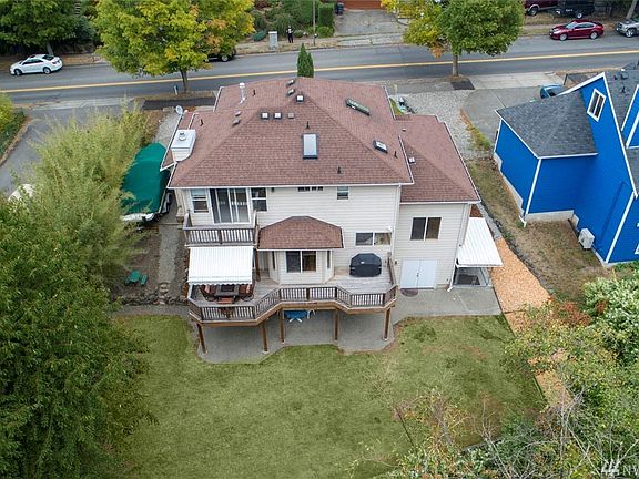 From above, view the large 1/3 acre lot.  Low maintenance landscaping is framed by bamboo and greenbelt beyond. RV/boat storage is an added bonus as well as a fenced dog run. 