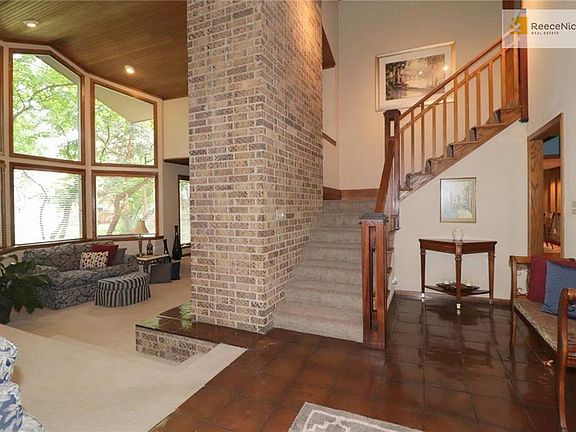 View of living room from entry hall.  New carpet on stair, 2nd floor hallway & three 2nd floor bedrooms.