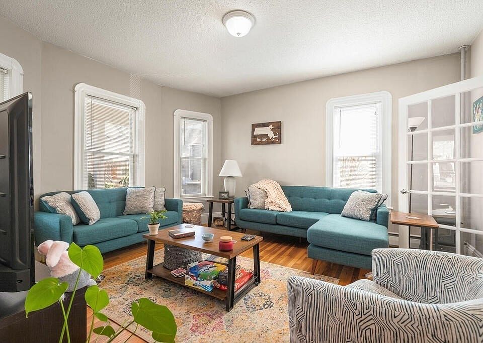 Living Room with bay windows, french doors, high ceilings