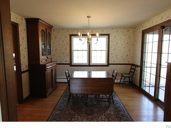 Formal dining room with French sliders to large screened porch.
