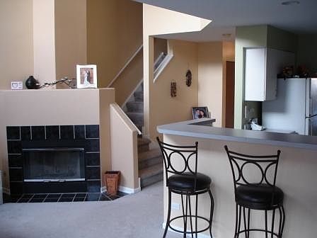 Living room with fireplace; breakfast bar