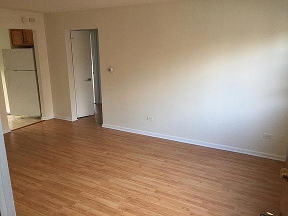 Living room has a walk in close that is not visible in this photo