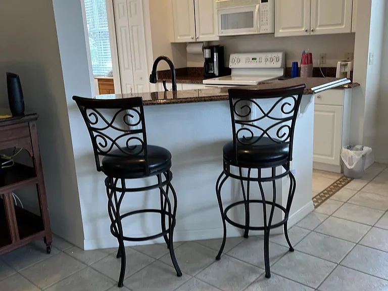 Kitchen has a little bar area.