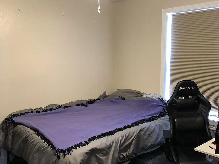 Bedroom with ceiling fan, mirrored closet, closet organizers ceiling fan, and room darkening shades